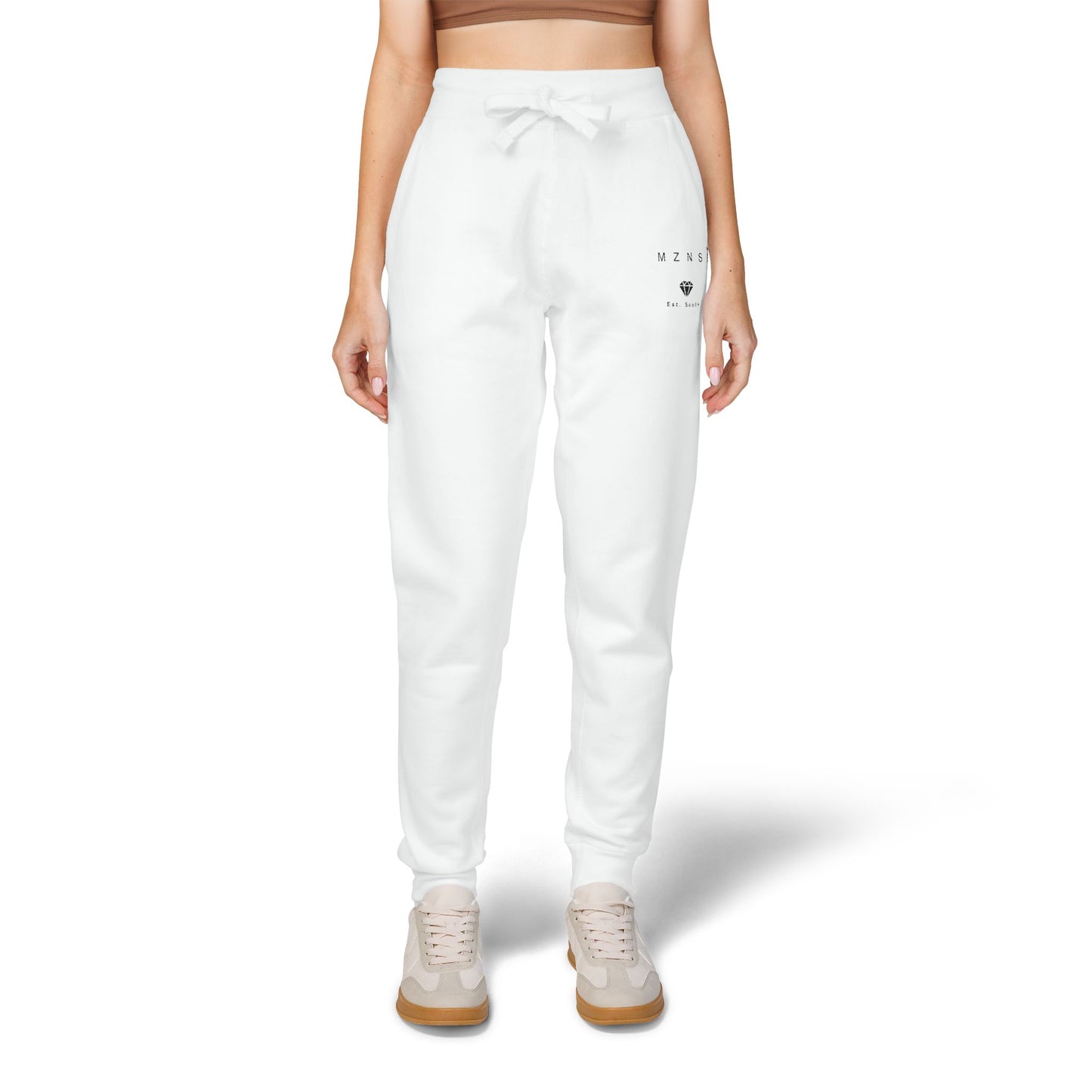 White sweatpants worn by a person on a white background
